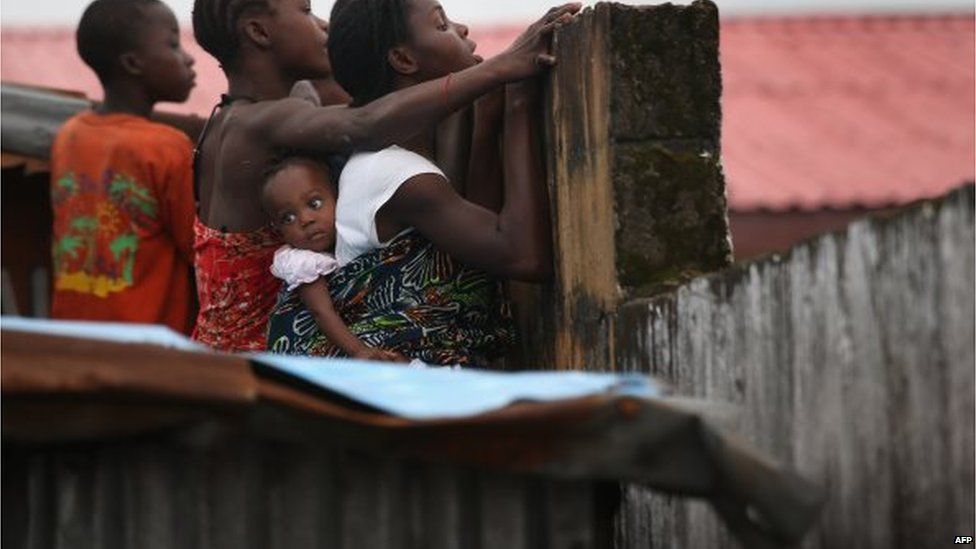 A crowd looks over the wall in Monrovia, Liberia.