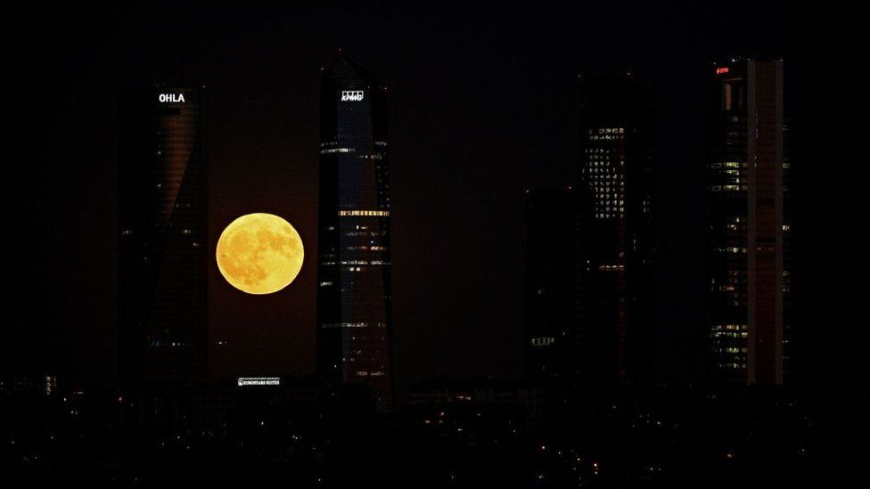 The Sturgeon Moonover the Cuatro Torres business area in Madrid.