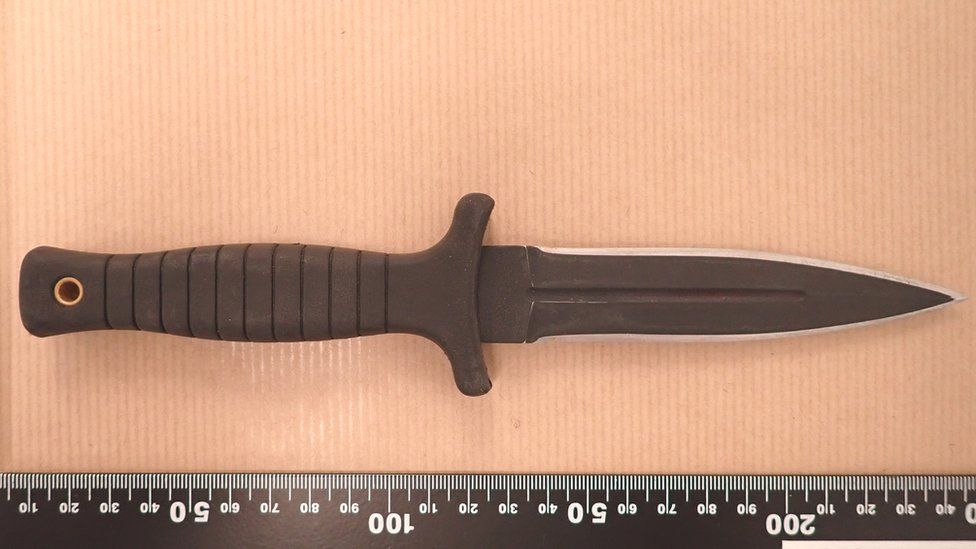 The knife used in the attack shown against a measurement rule