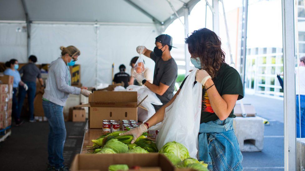 Volunteers pack bags of food at the San Francisco-Marin Food Bank