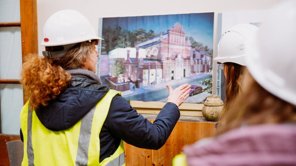 Jacob Wells Baths plans being studied by people in hard hats