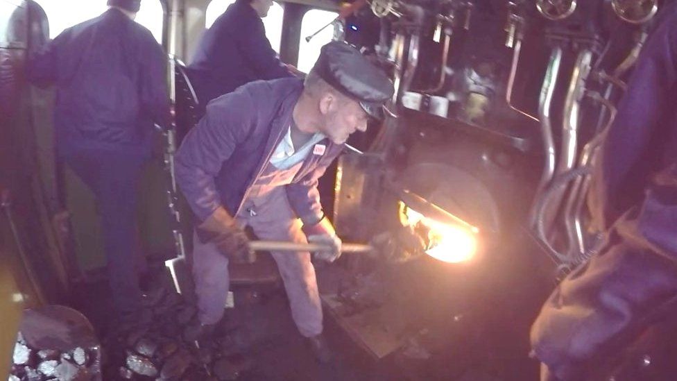 Train crew member fuelling the Tornado locomotive