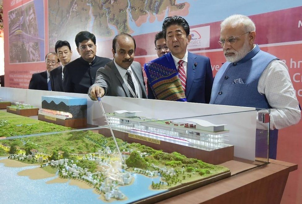 This handout photograph released by India"s Press Information Bureau (PIB) on September 14, 2017 shows Indian Prime Minister Narendra Modi (L) and Japanese Prime Minister Shinzo Abe looking at a railway station model at a ground breaking ceremony for the Mumbai-Ahmedabad high speed rail project in Ahmedabad. India"s first bullet train project, a $19-billion initiative linking Ahmedabad to Mumbai, was launched September 14