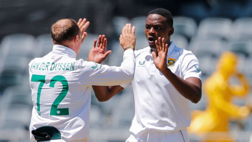 South Africa's Rassie van der Dussen (L) celebrates with teammate Kagiso Rabada after taking a catch to dismiss unseen Indian batsman during the first day of the second Test cricket match between South Africa and India at The Wanderers Stadium in Johannesburg, South Africa - Monday 3 January 2022