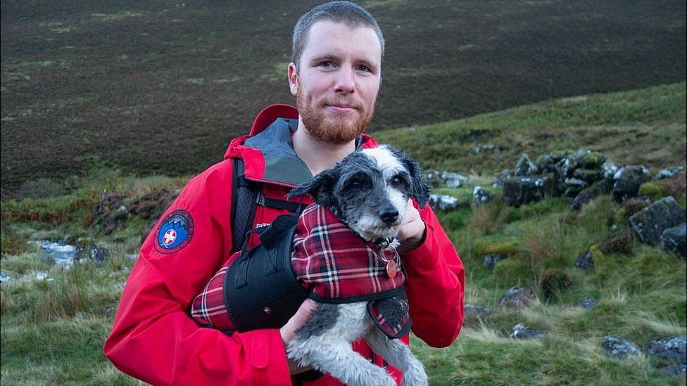 Keswick Mountain Rescue Team member with tired terrier