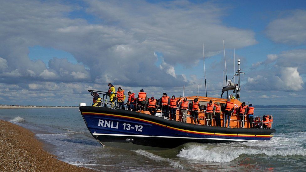 A group of people thought to be migrants are brought into Dungeness, Kent