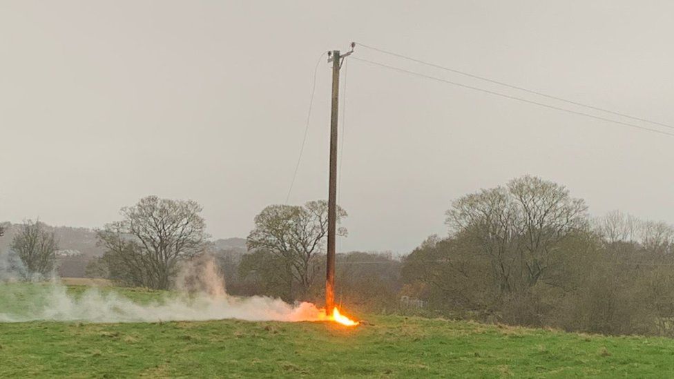 Fire at the bottom of a power telegraph pole