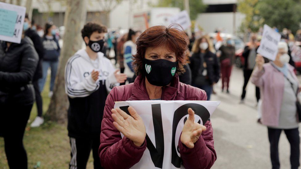 A demonstrator attends a protest against the regional government's measures to control the spread of the coronavirus disease (COVID-19), at Vallecas neighbourhood in Madrid, Spain, October 4, 2020.