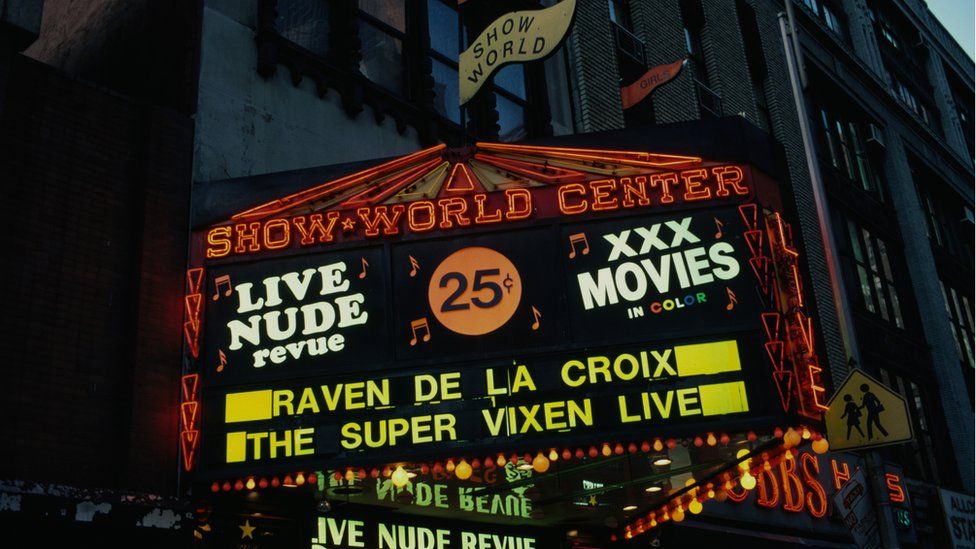 A neon sign for Live Nude review in New York's Show World centre