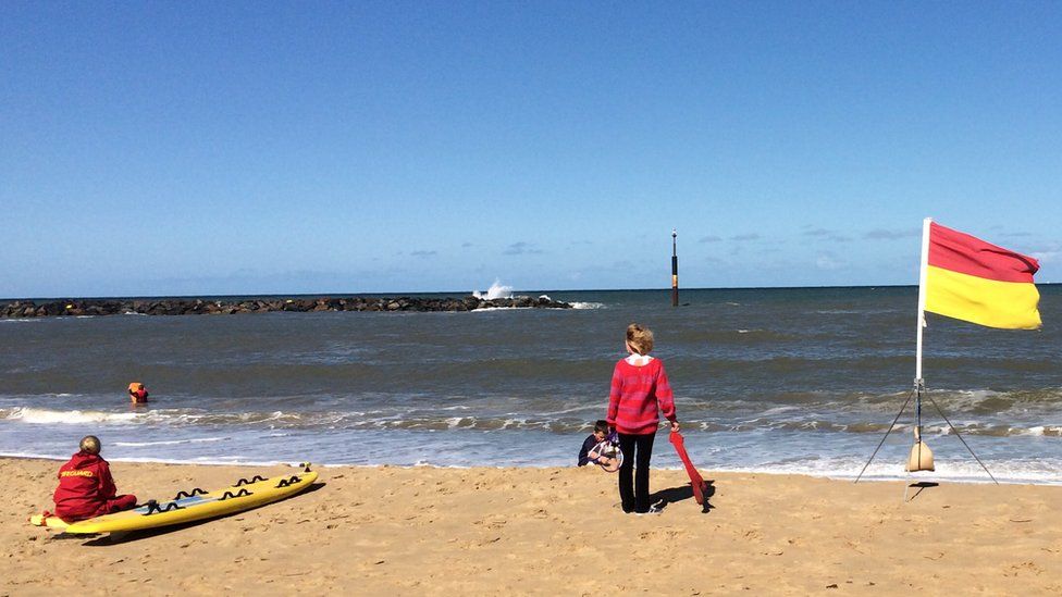 An RNLI red and yellow flag on a beach
