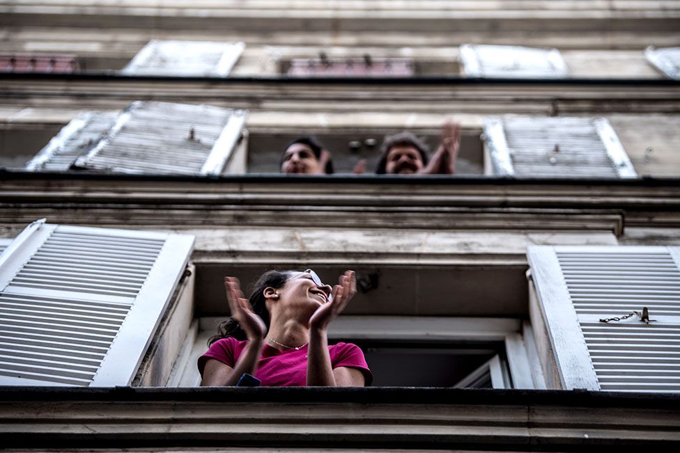 Parisians applauding from their window
