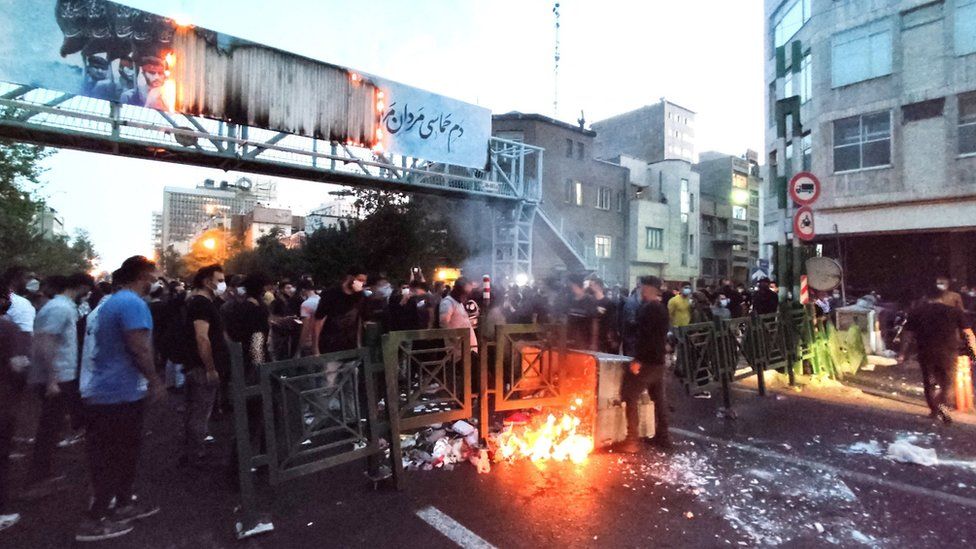 File photo showing people gathered around a fire during an anti-government protest sparked by the death of Mahsa Amini, in Tehran, Iran (21 September 2022)