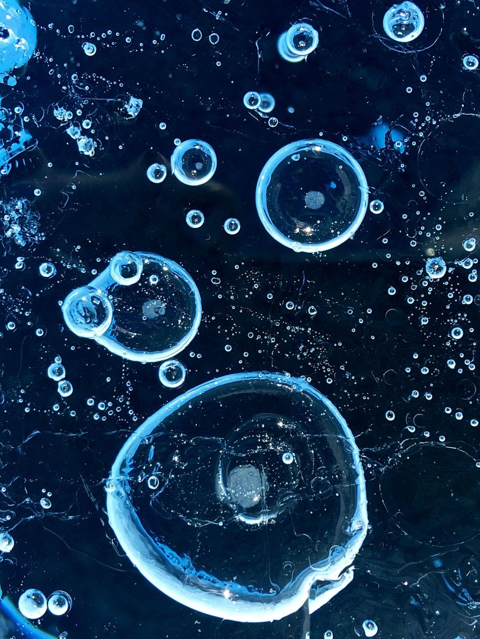 Air bubbles trapped in ice seen in a glacier