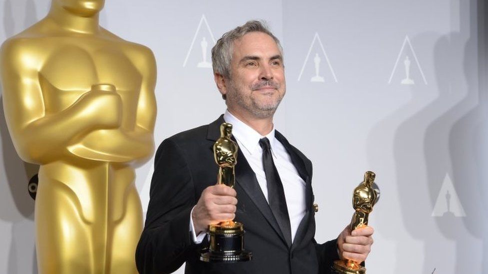 Alfonso Cuarón poses with Oscars ring the 86th Academy Awards in 2014