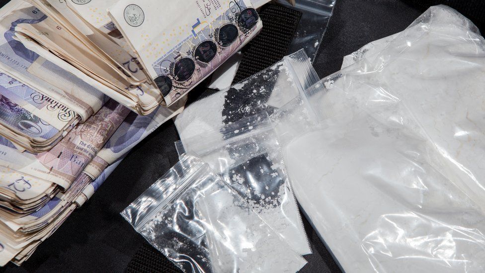 Pile of bank notes and drugs