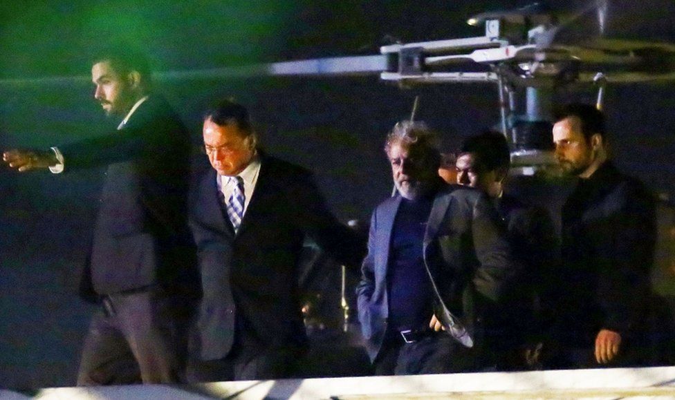 Lula leaves a police helicopter after arriving at the Federal Police headquarters in Curitiba