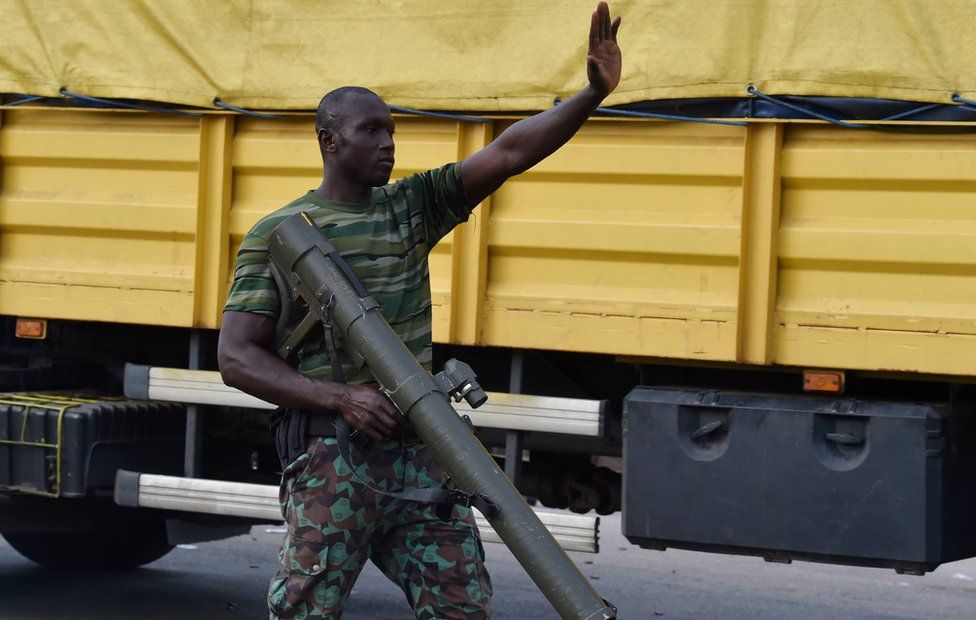 A mutinous soldier patrols in the streets of Ivory Coast's central second city Bouake, in May 14, 2017