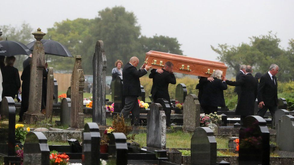 Mourners carry William Dunlop's coffin in the church cemetery