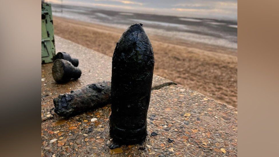 An unexploded artillery shell on the beach at Southend-on-Sea, Essex