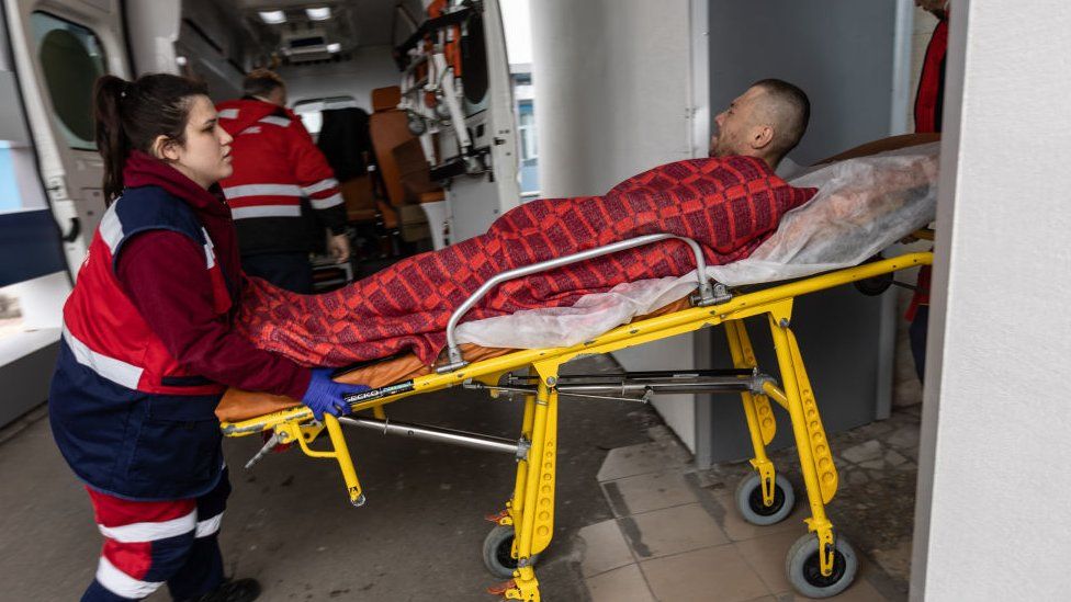 A man being taken into hospital in Irpin, Ukraine
