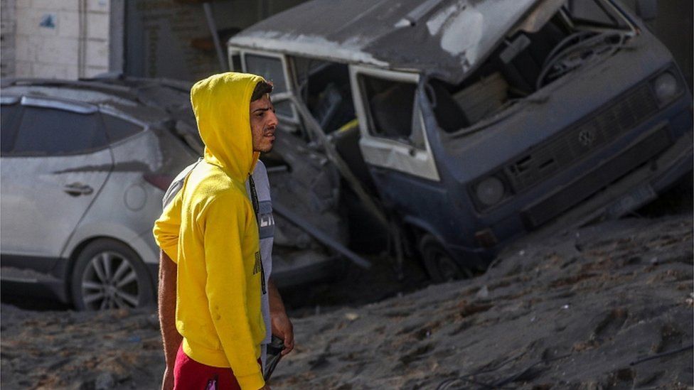 A man looks at the damage in the aftermath of overnight Israeli airstrikes on Gaza City