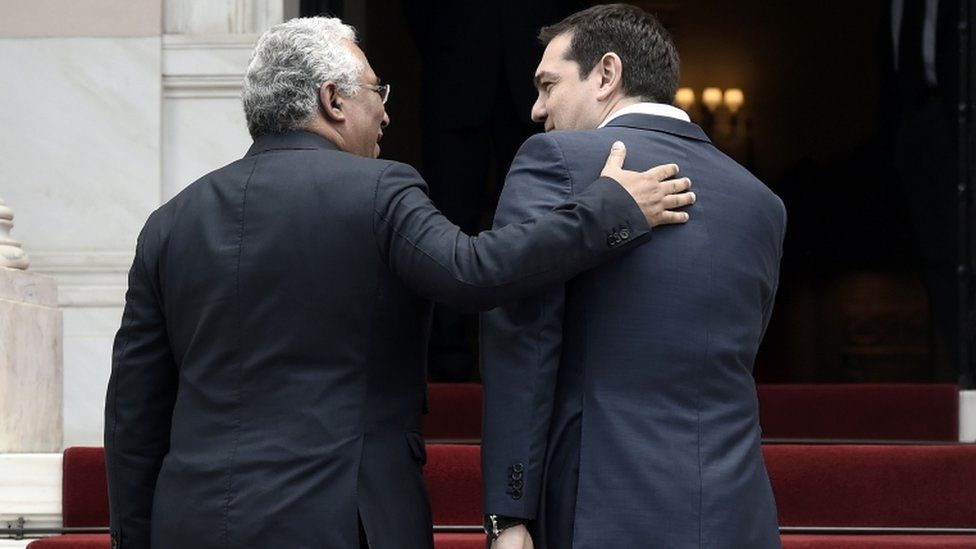 Greek Prime Minister Alexis Tsipras (R) welcomes his Portuguese counterpart Antonio Costa prior to their meeting in Athens