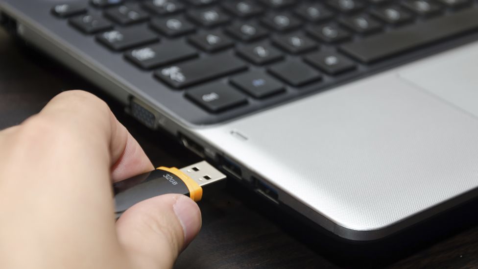 memory stick being inserted into laptop