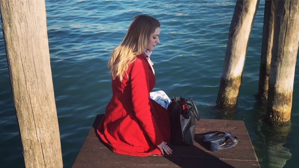Rachel sitting on a jetty