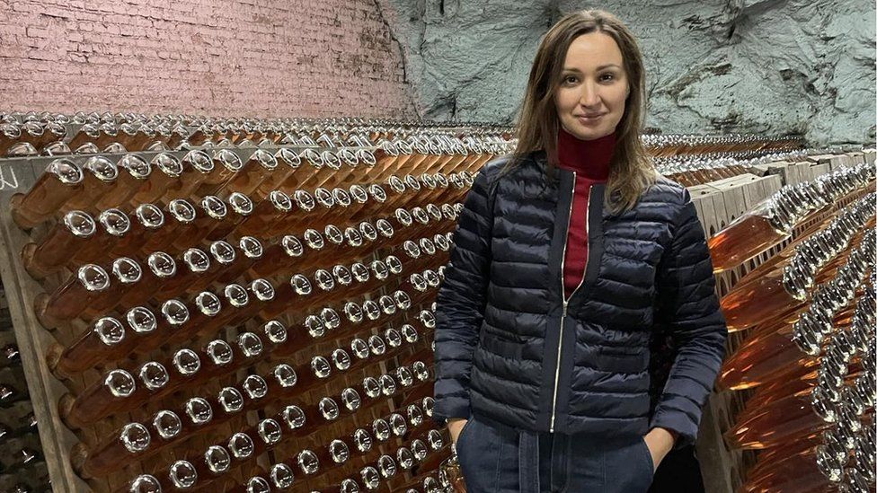 Oleksandra Cherednychenko standing in a wine cellar