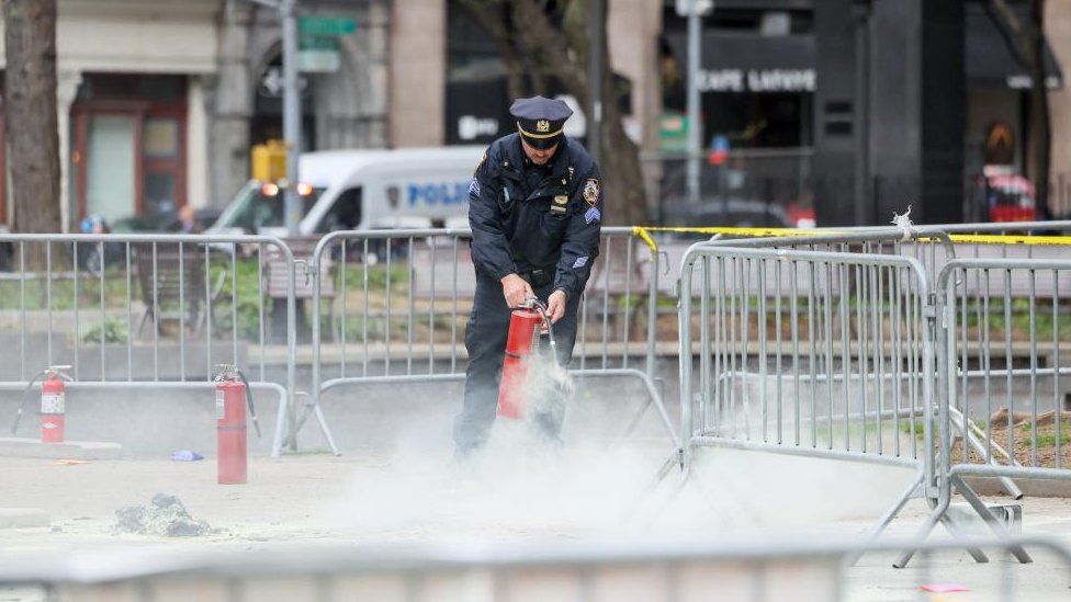 A policeman with a fire extinguisher