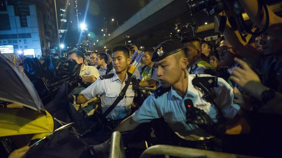 Police use pepper spray to stop protesters charging outside the Chinese Liason Office in Hong Kong on 6 November 2016, during a protest against an expected interpretation of the city's constitution - the Basic Law - by China's National People"s Congress Standing Committee (NPCSC) over the invalid oath-taking attempts by newly elected lawmakers Baggio Leung and Yau Wai-ching at the Legislative Council last month.