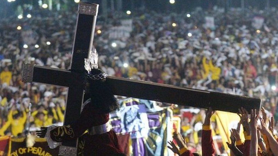 Thousands of Filipino devotees carry the statue of the Black Nazarene during the annual religious procession in Manila. 9 January 2017.