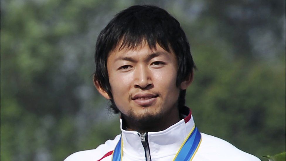 Joint bronze medallist Yasuhiro Suzuki of Japan attends the medal ceremony for the men's kayak single 1000m final at the International Rowing Centre in Guangzhou during the 16th Asian Games