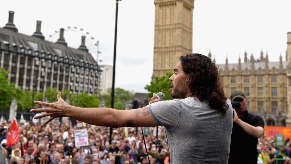 Comedian Russell Brand speaks to thousands of demonstrators gathered in Parliament Square to protest against austerity and spending cuts on June 20, 2015 in London, England.
