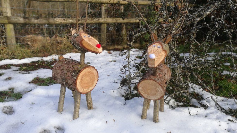 Wooden reindeer Bert and Ernie in the snow