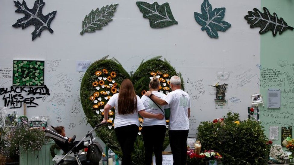 People pay their respects to 72 victims who died in the fire