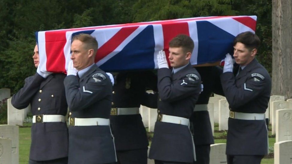 RAF serviceman carry a coffin draped in a union flag