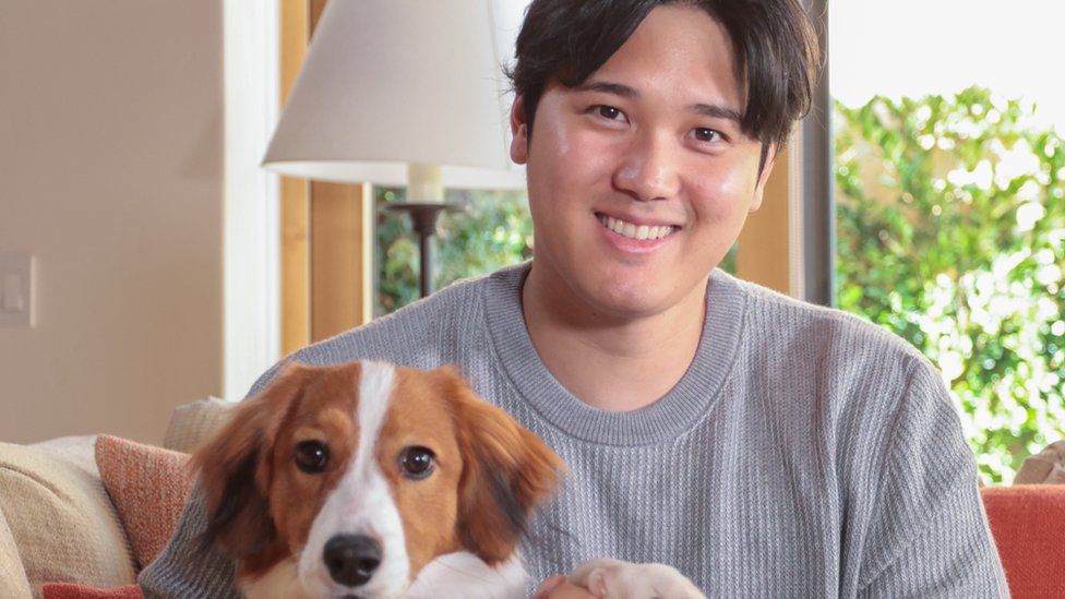 Shohei Ohtani poses for a photo with his dog prior to the announcement Ohtani winning the 2023 American League Most Valuable Player Award.