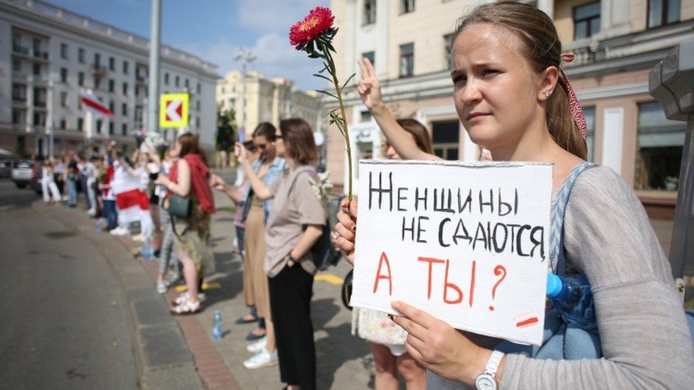 Protester in Minsk holds up sign saying: "Women don't surrender, and you?"