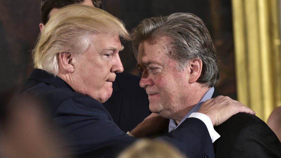 US President Donald Trump (L) congratulates Senior Counselor to the President Stephen Bannon during the swearing-in of senior staff in the East Room of the White House on 22 January, 2017 in Washington DC.