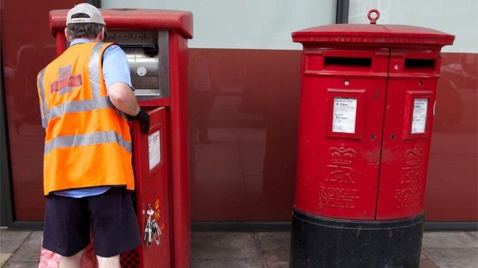 Postman empties letter box