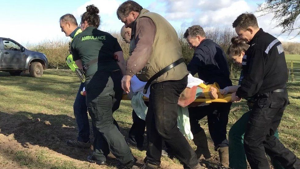 Henry being lifted away from the scene