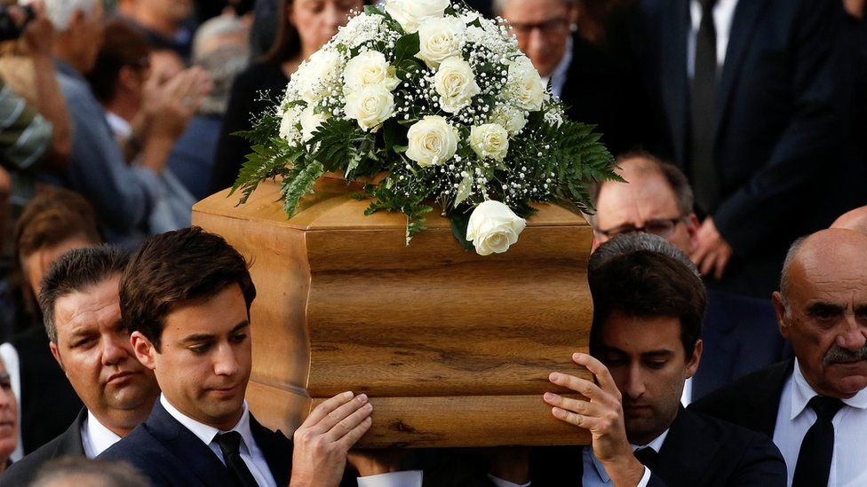 Journalist Daphne Caruana Galizia"s sons Matthew and Paul carry the coffin of their mother, who was murdered in a car bomb attack