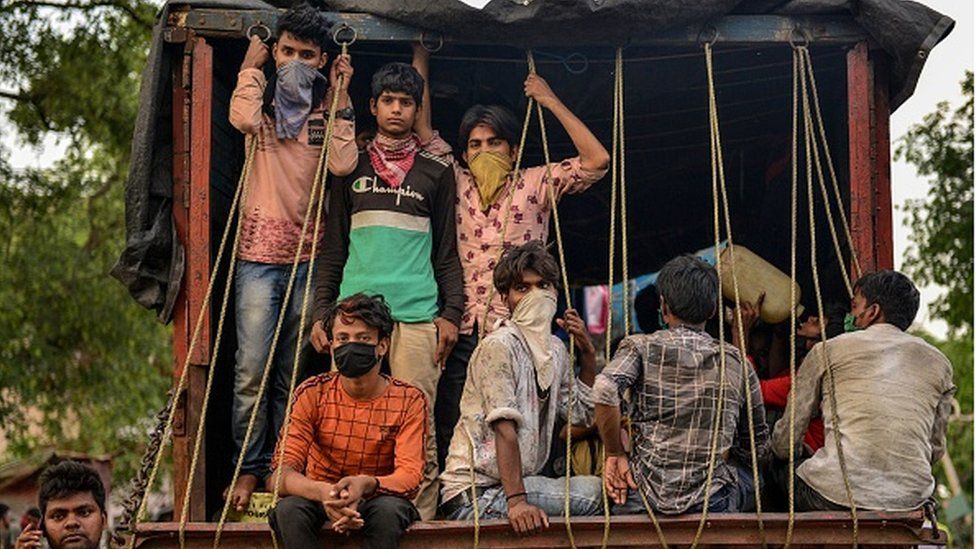 Migrant workers who arrived from Maharashtra state travel on a mini truck to go back to their hometowns, after the government eased a nationwide lockdown imposed as a preventive measure against the COVID-19 coronavirus, in Allahabad on May 15, 2020.