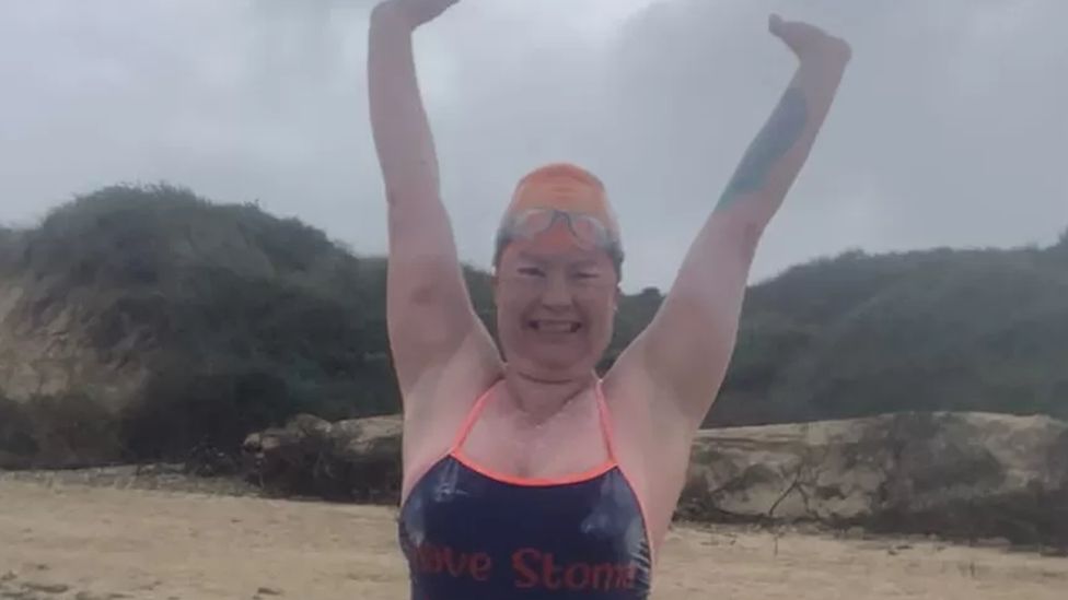 Gill Castle standing on a beach in France having completed her Channel Swim