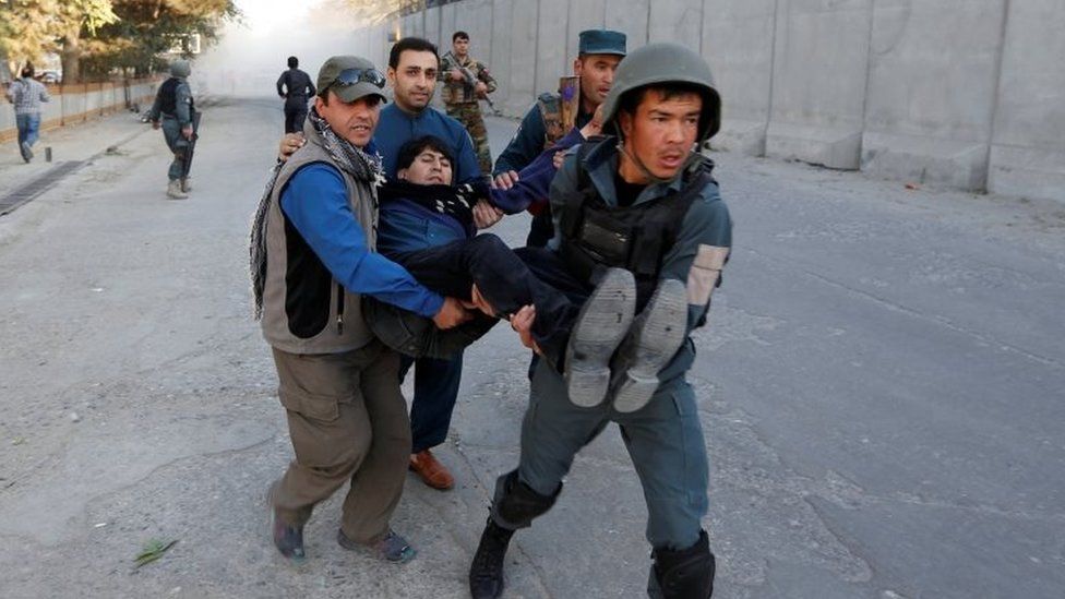 Afghan policemen carry an injured man after the blast in Kabul, Afghanistan 31 October, 2017