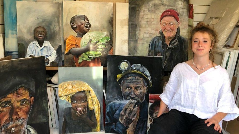 Makenzy Beard, 14, with a selection of her paintings