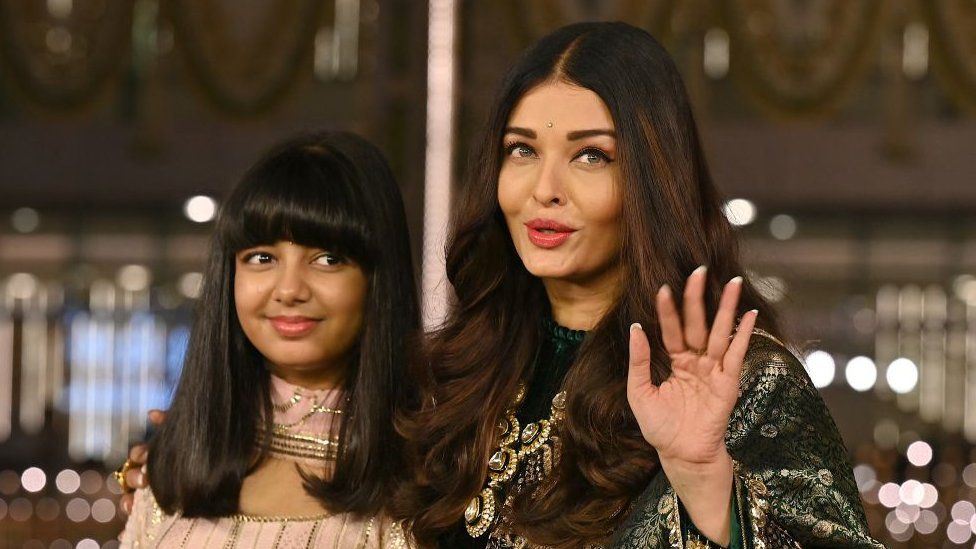 In this picture taken on March 31, 2023, Bollywood actress Aishwarya Rai Bachchan (R) and her daughter Aaradhya Bachchan pose for pictures during the inauguration of the Nita Mukesh Ambani Cultural Centre (NMACC) at the Jio World Centre (JWC) in Mumbai.