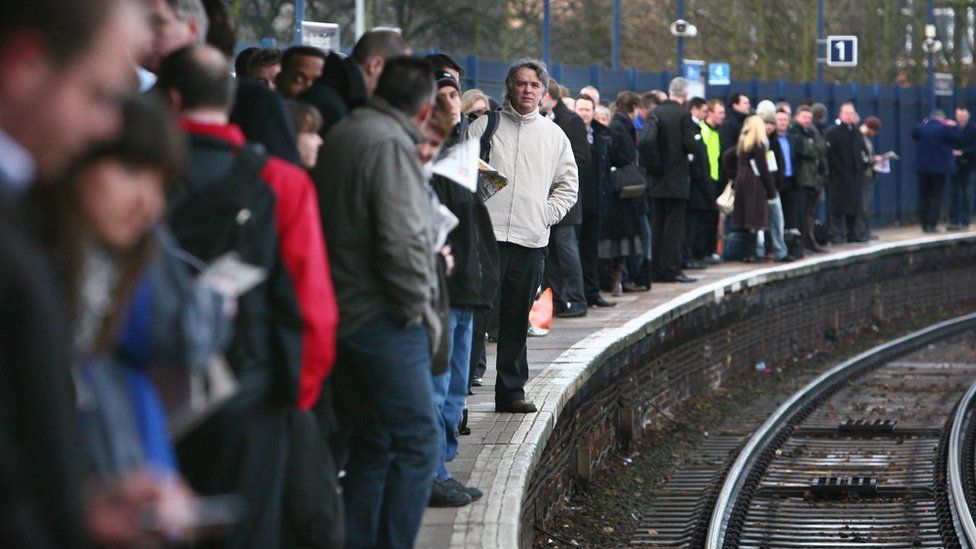 Commuters waiting on a platform