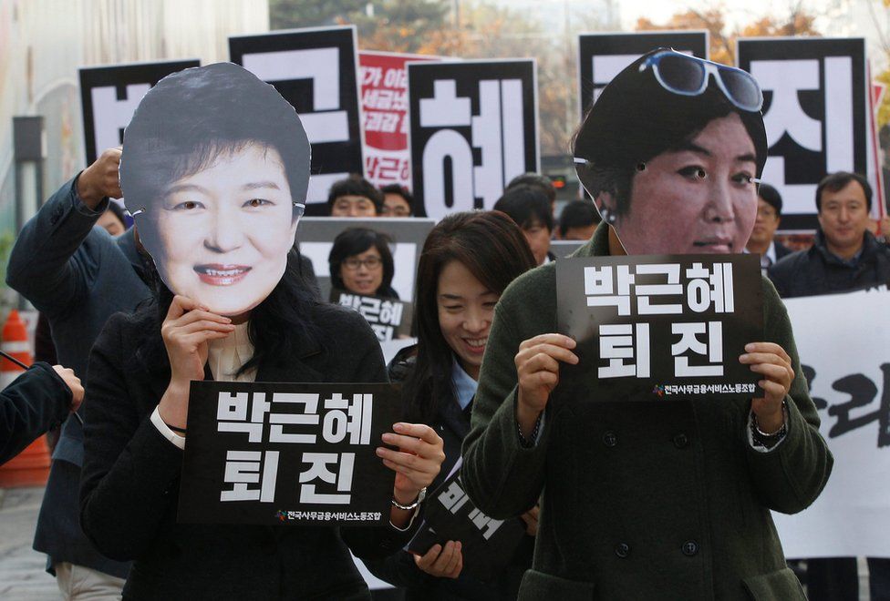 In this 18 November 2016, file photo, protesters wearing masks of South Korean President Park Geun-hye, left and Choi Soon-sil, Park's long-time friend, in Seoul, South Korea.